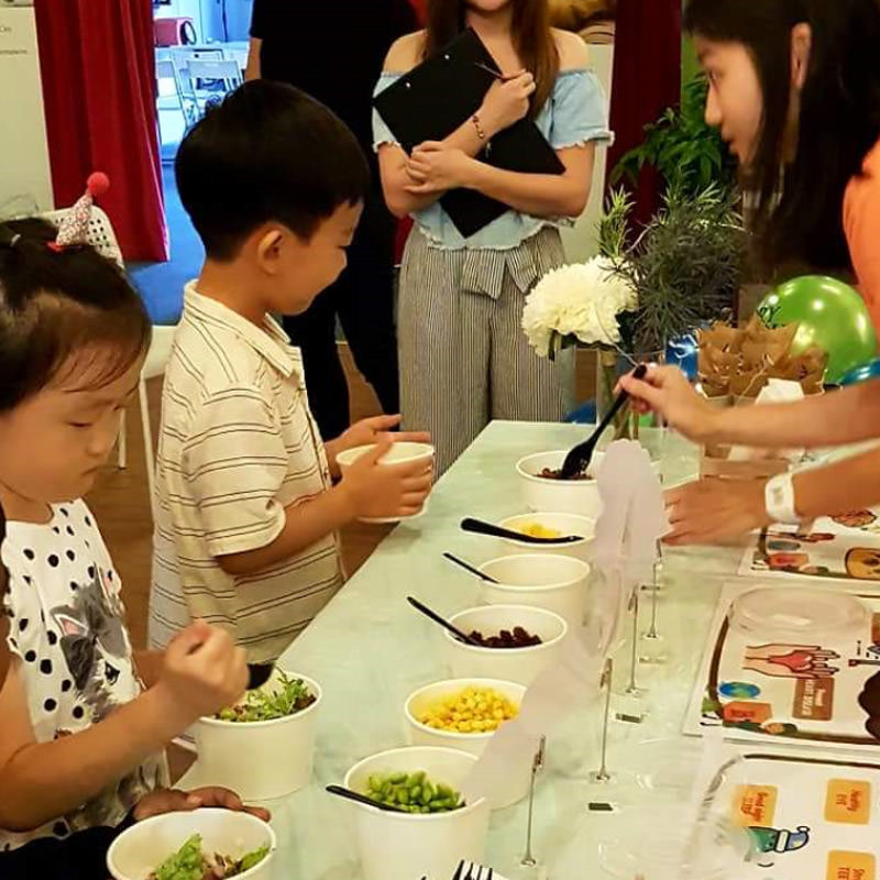 Children customizing their own bowl